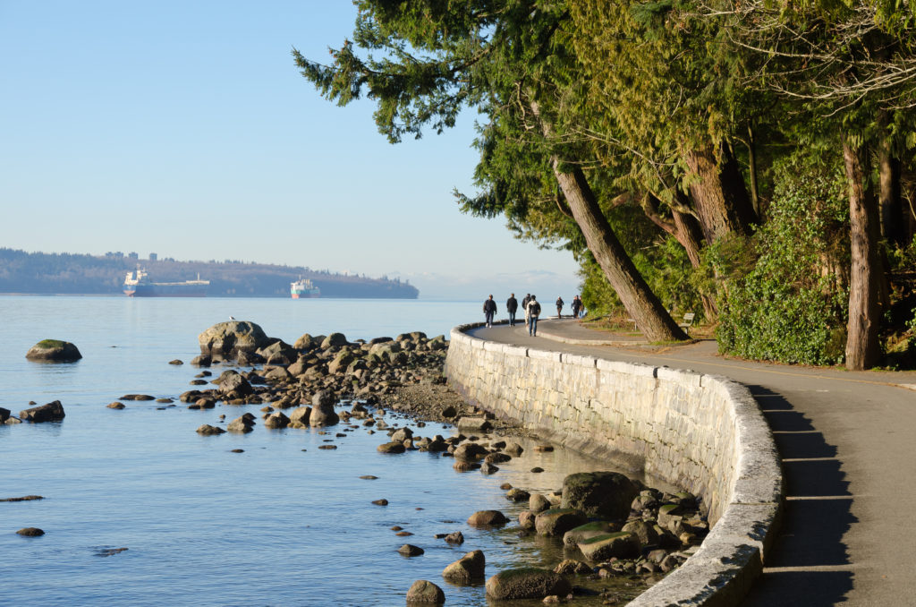 People walking along the Vancouver Seawall in British Columbia, Canada