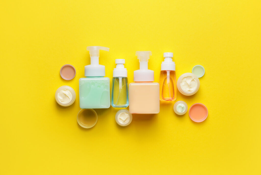 Various skincare products on a bright yellow backdrop