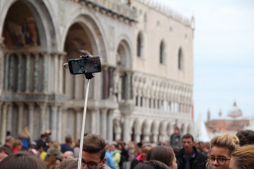 selfie stick in crowd in venice.