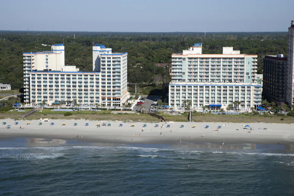 Aerial view from over the ocean looking at the Dunes Village Resort