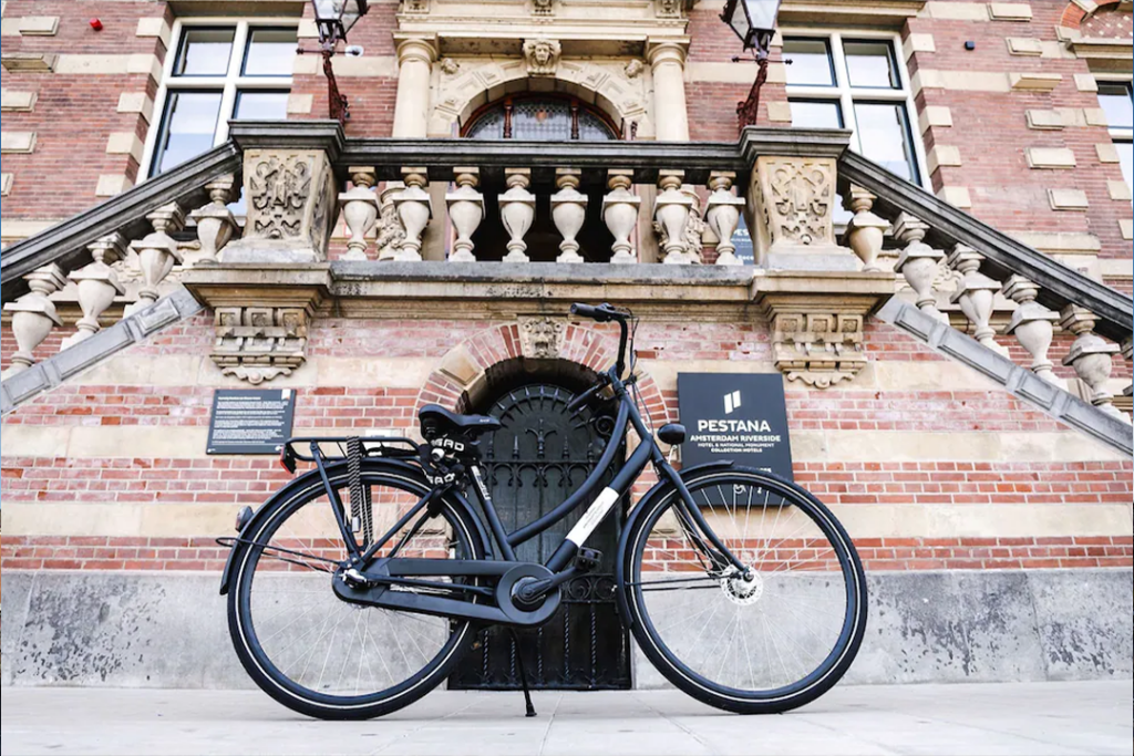 Black bicycle parked at the front entrance of the Pestana Amsterdam Riverside